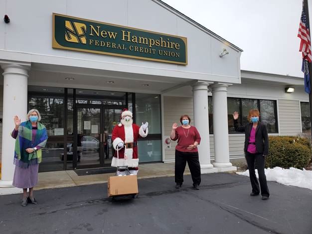 L to R, LuAnn Chapman, Santa, Karen Murphy and Carolyn Allhiser hand off Donations to Santa